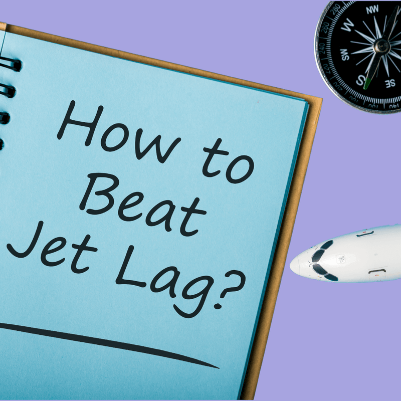  A notebook with a handwritten note reading "how to beat jet lag" with an airplane and compass in the background