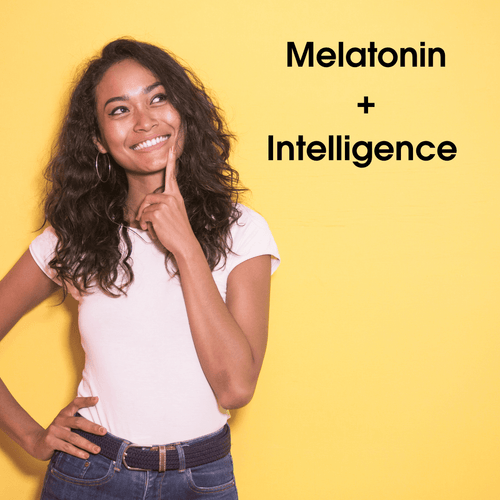 Woman thinking in front of yellow wall with melatonin + intelligence sign next to her